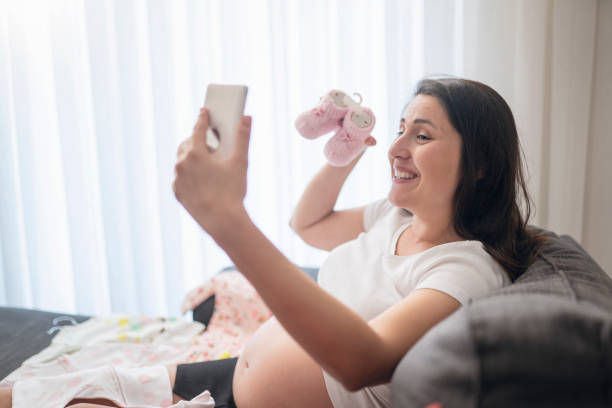 istock Baby clothes, taking photo 1190766650