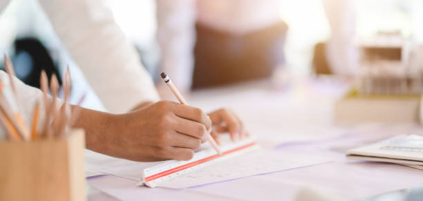 istock Cropped shot view of professional architect team working on working on construction plans in modern office 1190770027