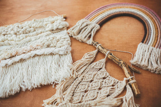 istock Stylish macrame and rainbow decoration on wooden table. Modern boho wall hanging and rope rainbow for baby room or simple stylish girl room. Wall macrame decor 1190771650