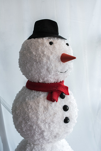 Snowman decoration in Christmas and party, Santa toy or snowman doll decorate on pine cone, symbol of celebration background of Christmas light, Dolls in a red hat and scarf design for Christmas day.