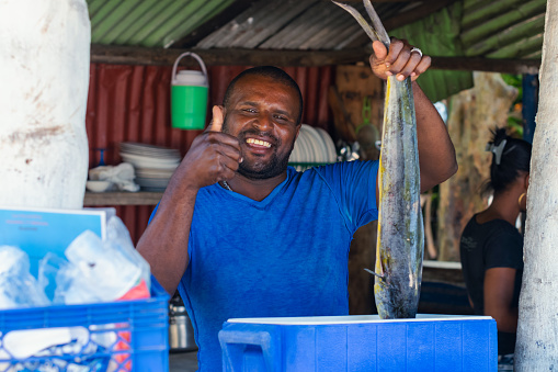 Fisherman holding fish in local restaurant in Las Galeras, Dominican republic.