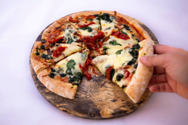 istock Spinach with dried tomateos and mzzarella cheese on pizza 1190773233