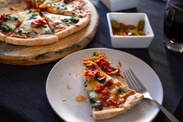 istock Spinach with dried tomateos and mzzarella cheese on pizza 1190773350