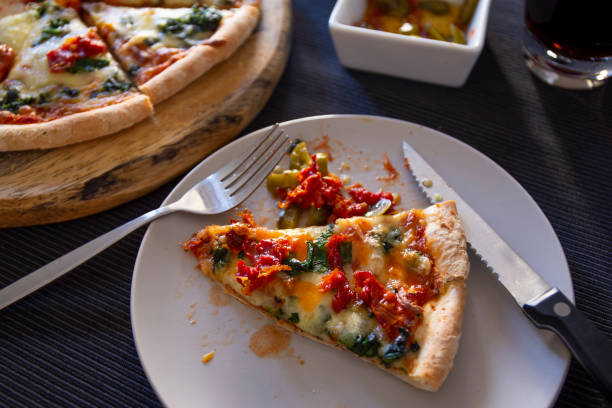 istock Spinach with dried tomateos and mzzarella cheese on pizza 1190773903