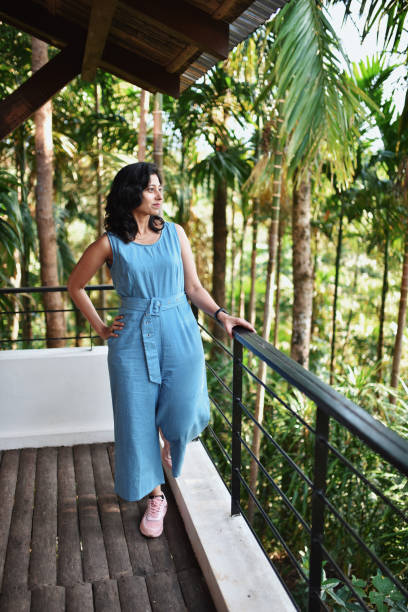 istock Woman standing in the balcony 1190776253