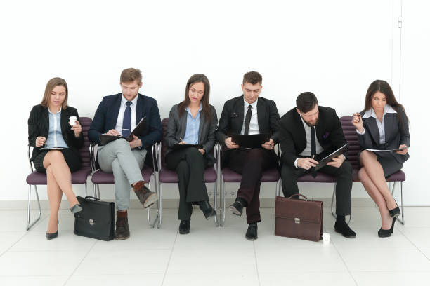 istock business team with clipboards sitting in a row 1190783418