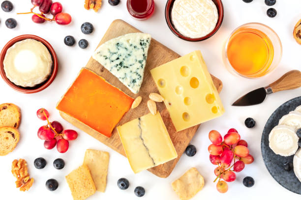 istock Cheese platter, a flat lay top shot on a white background. Blue cheese, red Leicester, Emmental, goat cheese, Brie and others with wine, fruits, nuts 1190785190