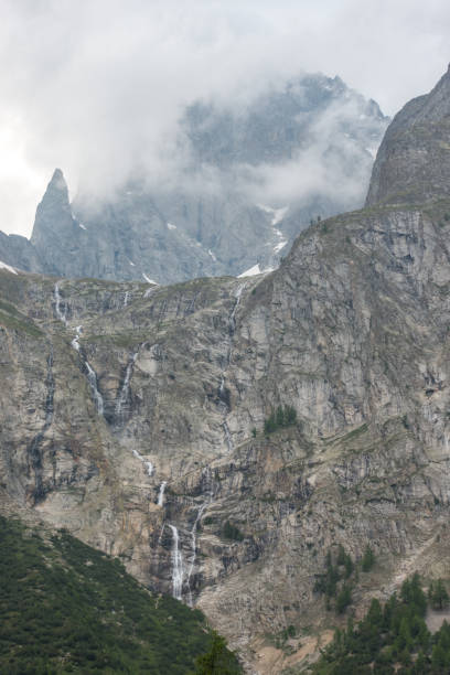 istock Fantastic view of the massive solid mountain rocks and the waterfalls coming down in the Italian Alps, Val Veny 1190786497