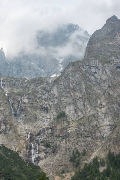 istock Fantastic view of the massive solid mountain rocks and the waterfalls coming down in the Italian Alps, Val Veny 1190786971