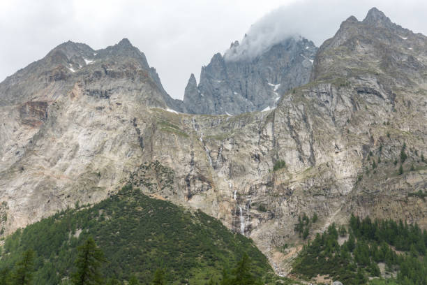 istock Fantastic view of the massive solid mountain rocks and the waterfalls coming down in the Italian Alps, Val Veny 1190786985