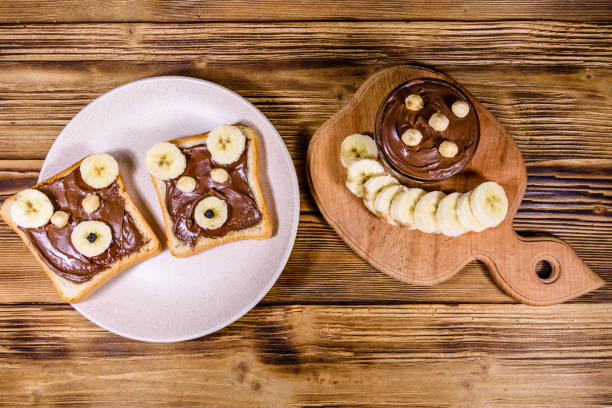 istock Two sandwiches with chocolate spread on a plate. Sandwich like a bear muzzle. Top view 1190788760