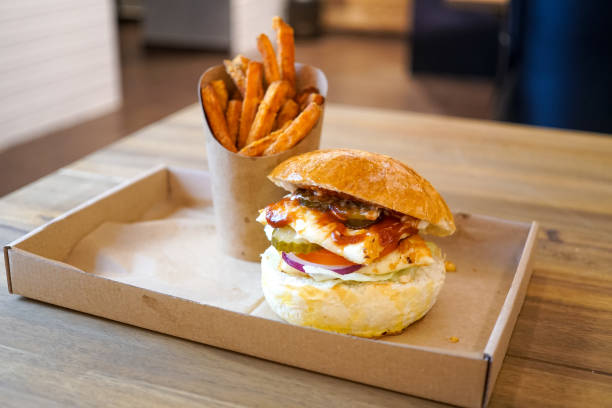 istock Meaty hamburger and fries on a table 1190790871