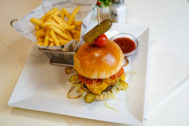 istock Meaty hamburger and fries on a table 1190791009