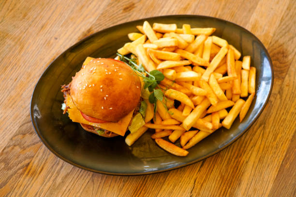 istock Meaty hamburger and fries on a table 1190791038
