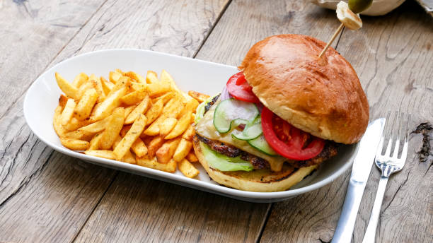 istock Meaty hamburger and fries on a table 1190791162