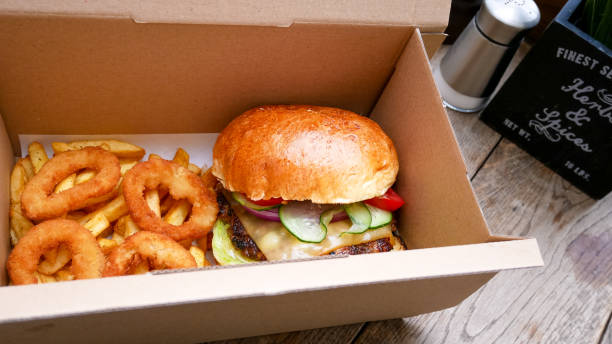 istock Meaty hamburger and fries on a table 1190791210