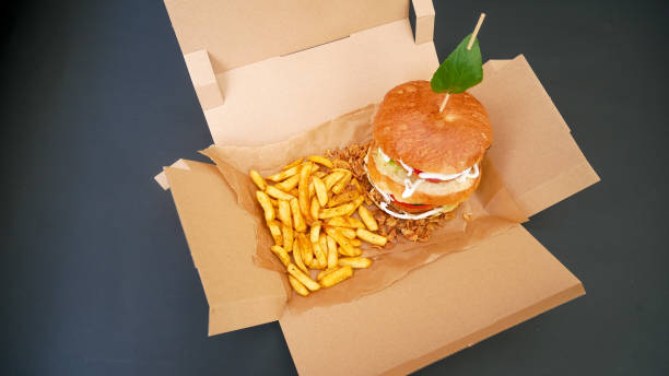 istock Meaty hamburger and fries on a table 1190791236