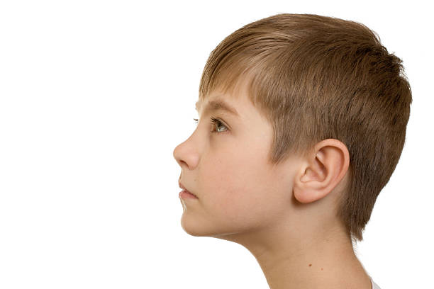 Headshot of Boy squeezing his face on the living room window