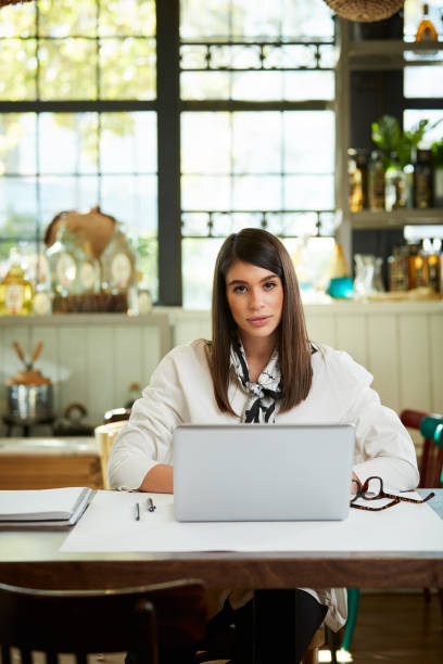 istock Businesswoman using laptop in cafe. 1190795614