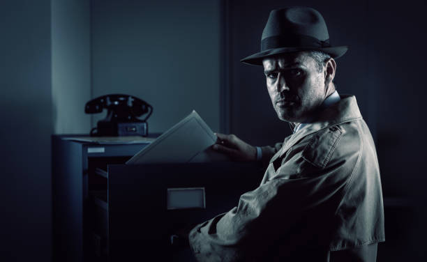 istock Vintage spy stealing files in the office 1190795617