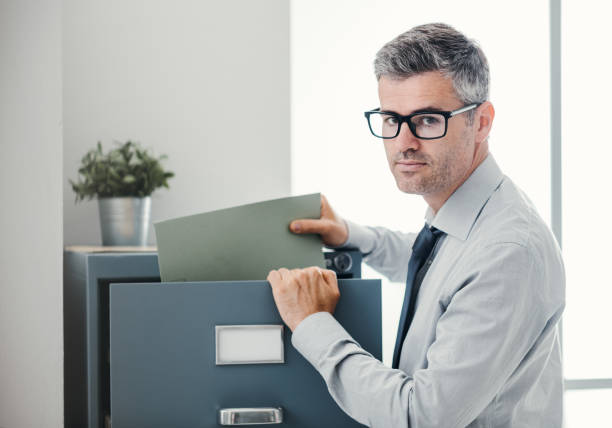 istock Office clerk searching files 1190795646