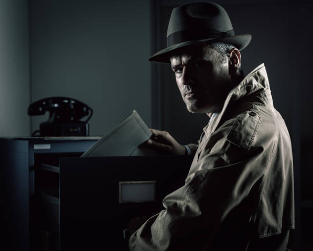 istock Vintage spy stealing files in the office 1190795723