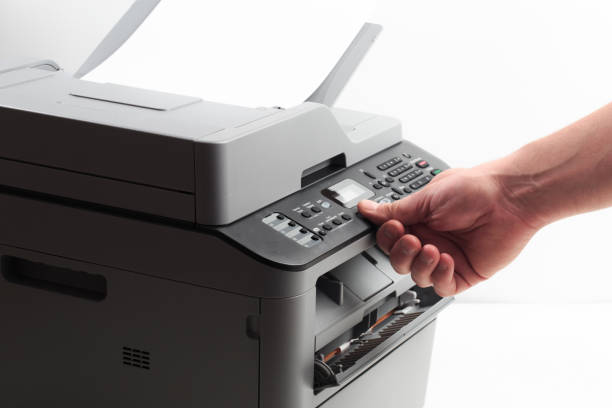 istock Hand press button on panel of printer. printer scanner laser office copy machine supplies start concept 1190798140