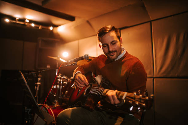 istock Handsome man enjoy playing guitar and performing, portrait. 1190798156