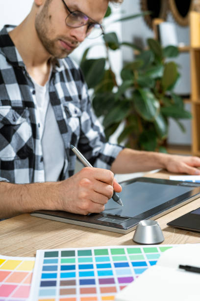 istock Young adult worker working with graphic tablet in office 1190798453