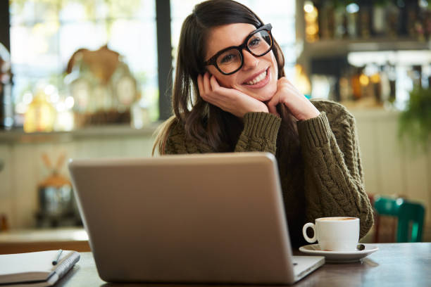 istock Woman posing with laptop in cafe. 1190798498