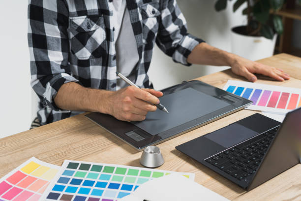 istock Young adult designer working with graphic tablet in office 1190798521