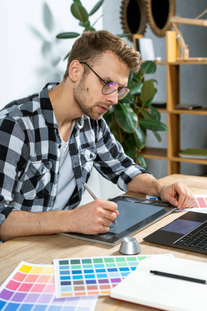 istock Young adult freelancer working with graphic tablet in office 1190798535