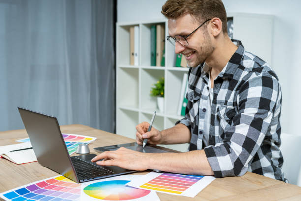 istock Young adult freelancer working with graphic tablet in office 1190798606