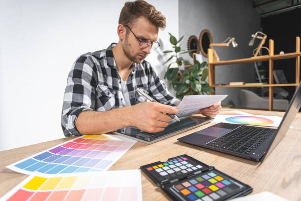 istock Young adult man working with graphic tablet in office 1190798685