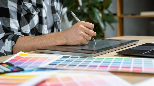 istock Young adult illustrator working with graphic tablet in office 1190798702