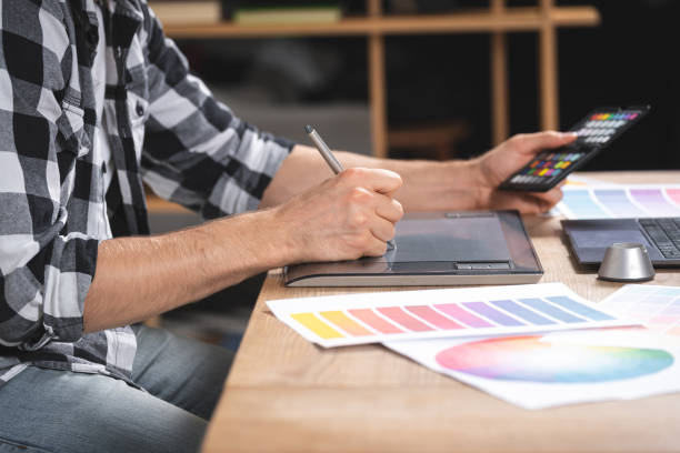 istock Young adult freelancer working with graphic tablet in office 1190799228