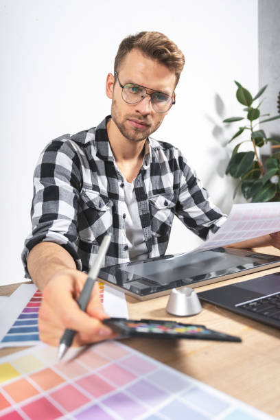 istock Young adult illustrator working with graphic tablet in office 1190799231