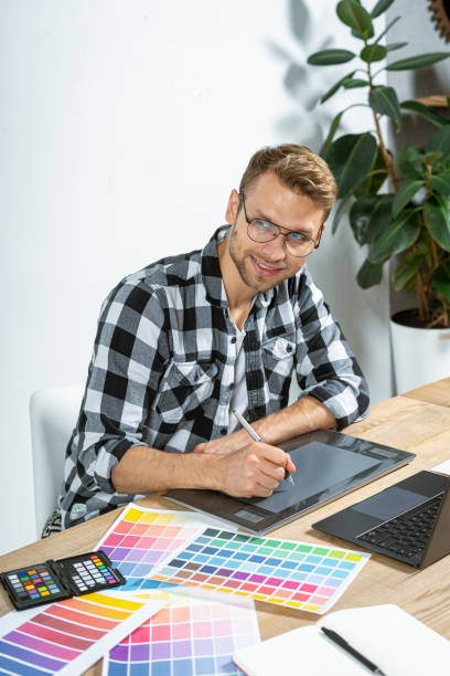 istock Young adult designer working with graphic tablet in office 1190799272