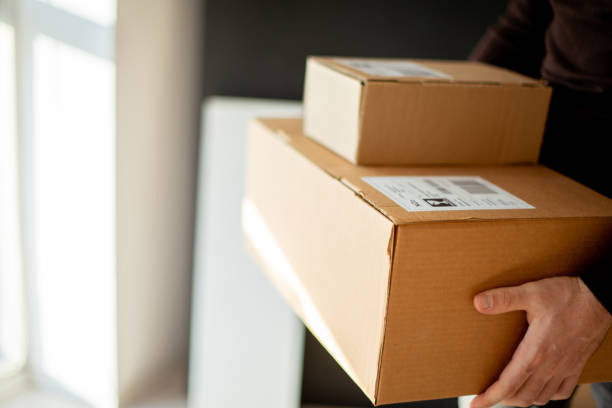 istock Young man carrying packages for shipment 1190799478
