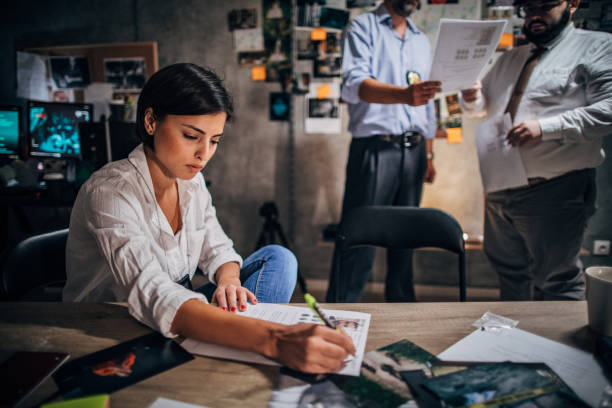 istock Woman detective working with colleagues in office 1190800296
