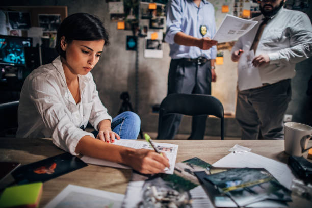 istock Lady detective working with colleagues in office 1190801006
