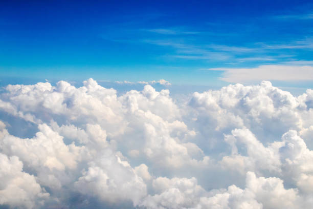 istock Blue sky with fluffy clouds; soft altocumulus and nimbostratus clouds in the sky. Skyscraper background view seen from the plane. 1190801472