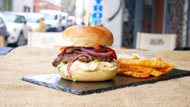 istock Meaty hamburger and fries on a table 1190802586