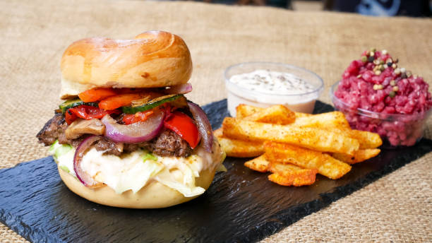 istock Meaty hamburger and fries on a table 1190802621