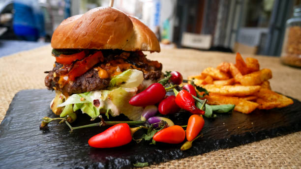 istock Meaty hamburger and fries on a table 1190802643