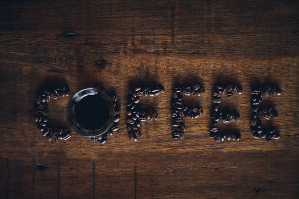 Coffee text/word made with Roasted Arabica coffee beans On Rustic Wooden background