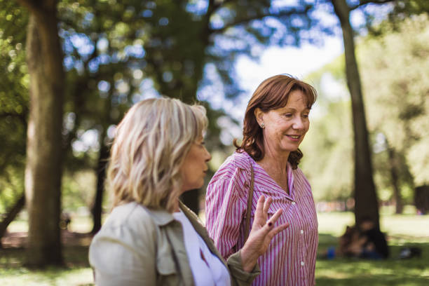 istock Senior girlfriends walking in a park 1190806218