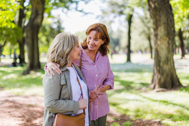 istock Senior girlfriends walking in a park 1190806246
