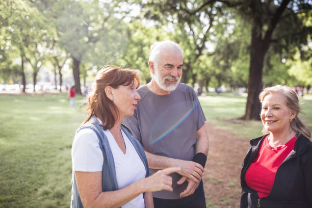 istock Group of seniors jogging in the park 1190806347