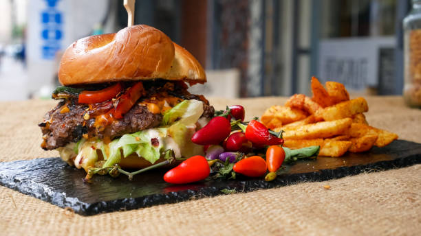 istock Meaty hamburger and fries on a table 1190806590